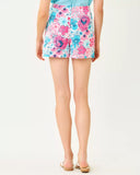 Woman wearing a colorful floral skirt on a white background